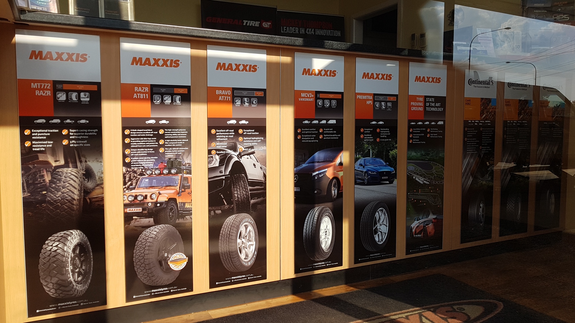 The tyre range display wall inside the workshop in late afternoon light